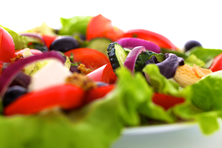 salad from fresh vegetables in a plate on a table, selective focusの写真素材