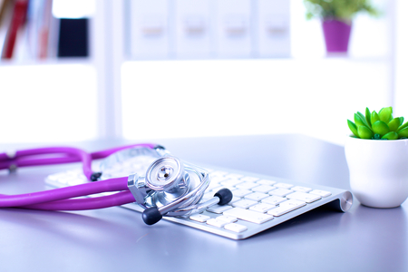 medical stethoscope with a computer on the deskの写真素材