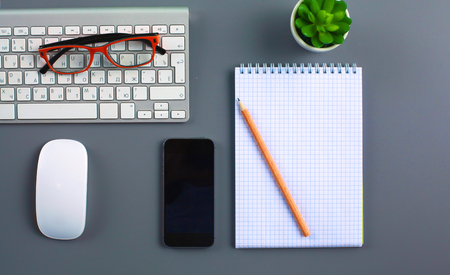 office desk with laptop, pen, and notebook. Top viewの写真素材