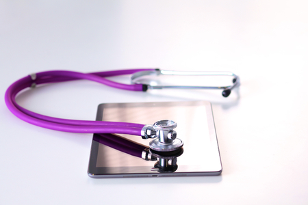 medical stethoscope with a computer on the deskの写真素材