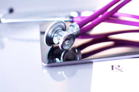medical stethoscope with a computer on the deskの写真素材