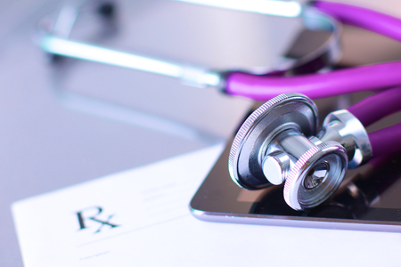 medical stethoscope with a computer on the deskの写真素材