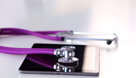 medical stethoscope with a computer on the deskの写真素材