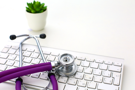 Medical stethoscope and a plate on the tableの写真素材