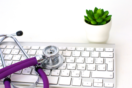 Doctors workspace working table with patients discharge blank paper form, medical prescription, stethoscope on deskの写真素材