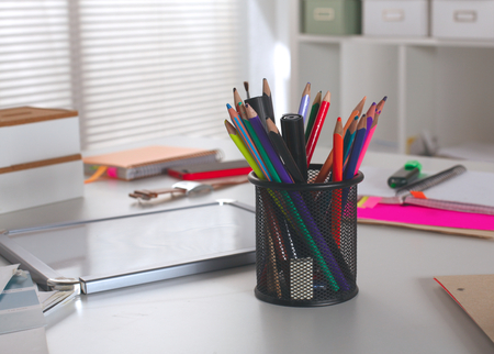 Office table with blank notepad and laptopの写真素材
