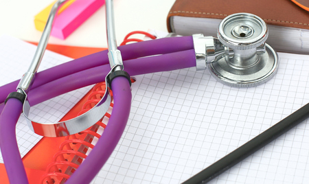 Doctors workspace working table with patients discharge blank paper form, medical prescription, stethoscope on deskの写真素材