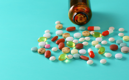 Medical pills and a bottle lie on the table. Medical conceptの写真素材