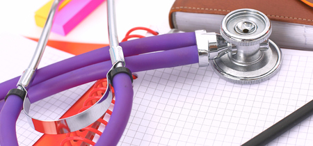 Doctors workspace working table with patients discharge blank paper form, medical prescription, stethoscope on deskの写真素材