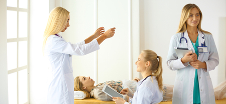 Attractive female doctor in front of medical groupの写真素材