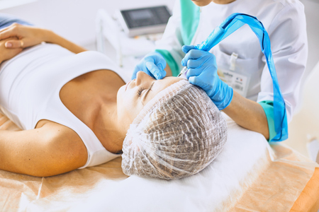 Permanent Makeup For Eyebrows. Beautiful Woman With Thick Brows In Beauty Salon. Beautician Doing Eyebrow Tattooing For Female Face. Beauty Procedureの写真素材