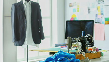 Retro sewing machine on designer clothes desktopの写真素材