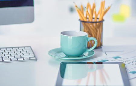 A cup of coffee on the office table.の写真素材