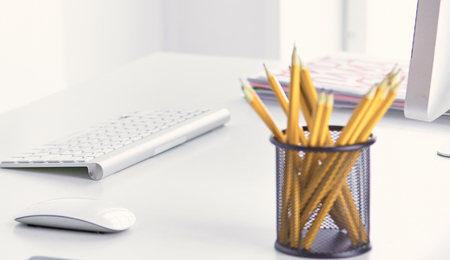 Graphite pencils in a metal grid-container on the office table.の写真素材