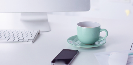 A cup of coffee on the office tableの写真素材