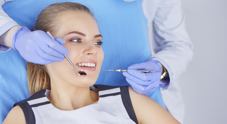 beautiful girl in the dental chair on the examination at the dentistの写真素材