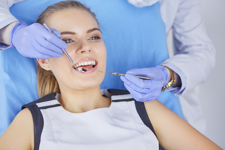 beautiful girl in the dental chair on the examination at the dentistの写真素材