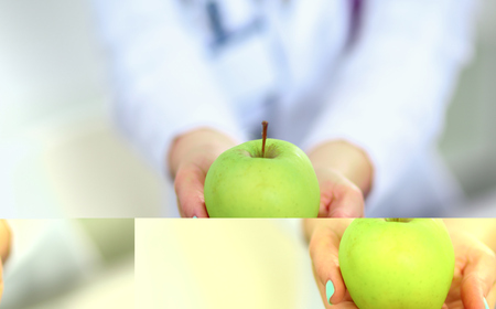 Doctor holding fresh green apples, closeup shotの写真素材