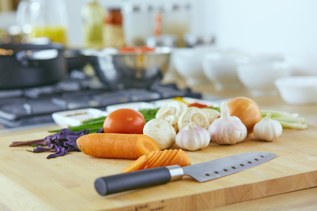 Composition with wooden board and ingredients for cooking on tableの写真素材