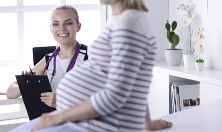 Gynecology consultation. Pregnant woman with her doctor in clinicの写真素材