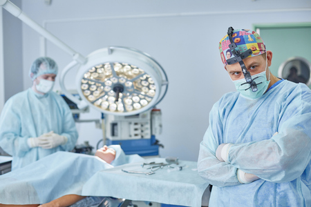 Several doctors surrounding patient on operation table during tの写真素材