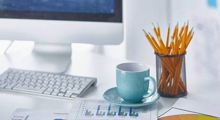 A cup of coffee on the office tableの写真素材