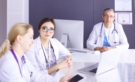 Doctors having a medical discussion in a meeting roomの写真素材