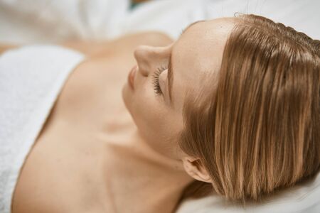 Beautiful young woman in cosmetic salon close upの写真素材