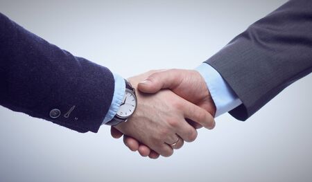 Business handshake. Two businessman shaking hands with each other in the office.の写真素材