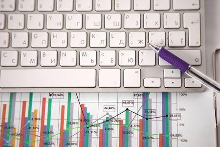 Office table with blank notepad and laptopの写真素材