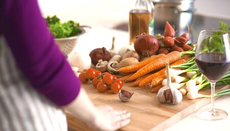 Young Woman Cooking in the kitchen. Healthy Food.の写真素材