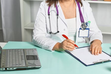 female doctor at the table in the officeの写真素材