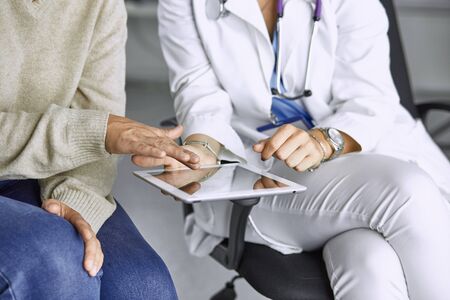 female doctor talking to a patient on a tabletの写真素材