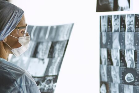 Two female women medical doctors looking at x-rays in a hospitaの写真素材