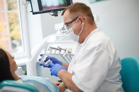 Doctor dentist treats teeth of a beautiful young girl patient. The girl on reception at the dentist....