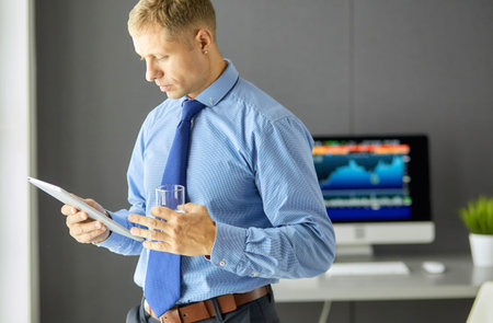 Young confident doctor in a white coat with a stethoscopeの写真素材