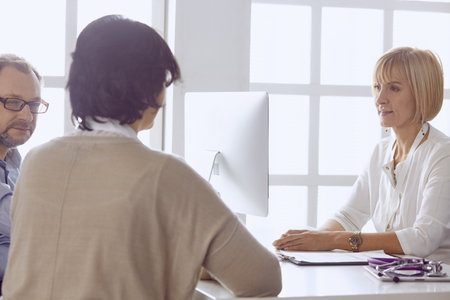 Couple at reception discussing issues with a sexologistの写真素材