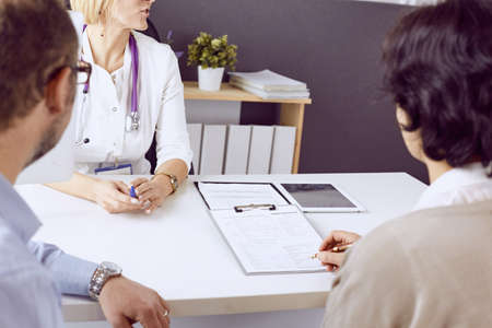 Couple at reception discussing issues with a sexologistの写真素材