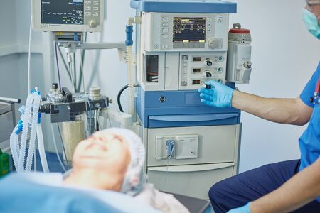 Several doctors surrounding patient on operation table during their work. Team surgeons at work in operating room.の写真素材