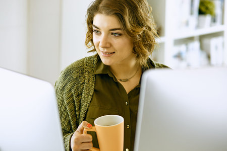 Young woman working with graphic tablet in office