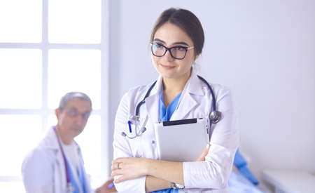 Doctor checking heart beat of patient in bed with stethoscopeの写真素材