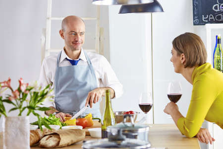 Smiling young couple cooking food in the kitchenの写真素材