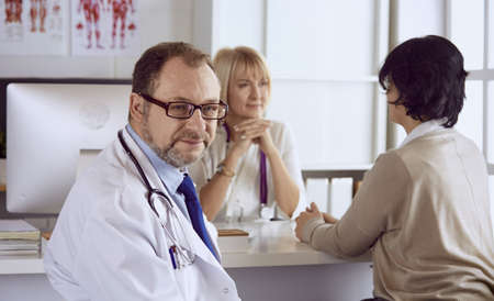 American doctor talking to woman in surgeryの写真素材