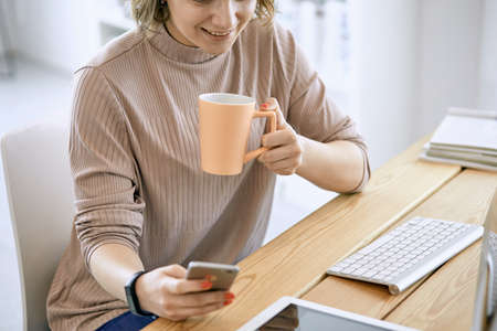 Young woman working with graphic tablet in officeの写真素材