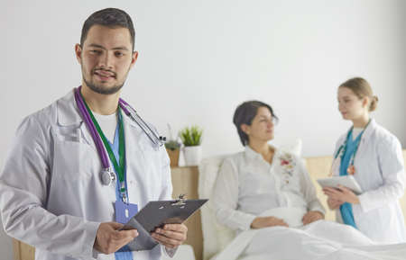 Patient with a group of doctors at the backgroundの写真素材