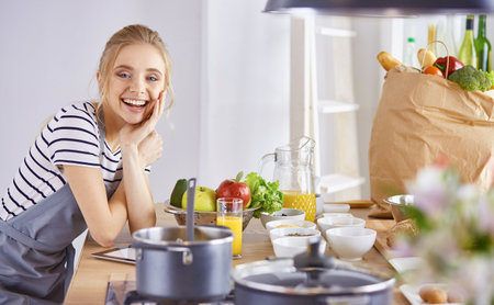 Young Woman Cooking in the kitchen. Healthy Foodの写真素材