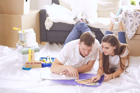Young Hispanic couple looking at blueprints of new home, high angle viewの写真素材
