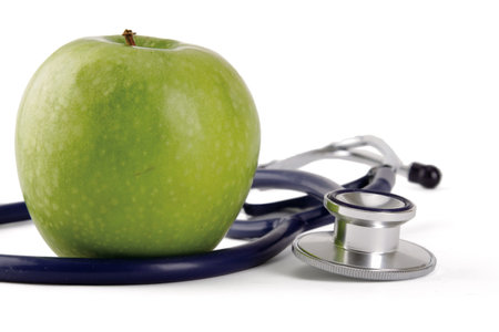 Stethoscope and green apple isolated on white backgroundの写真素材