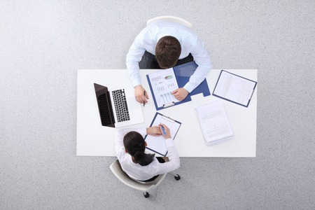 Business people sitting and discussing at business meeting, in officeの写真素材