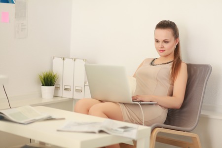 Woman with documents sitting on the desk の写真素材